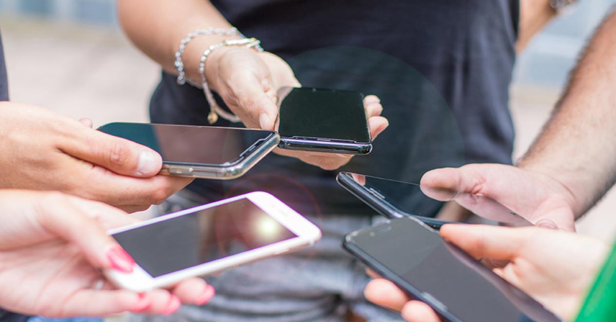 A group of people on their smartphones