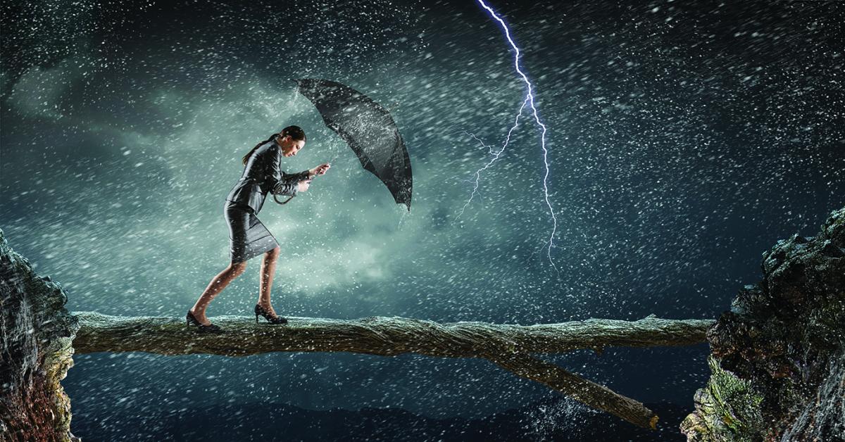 Woman with umbrella walking into a storm.