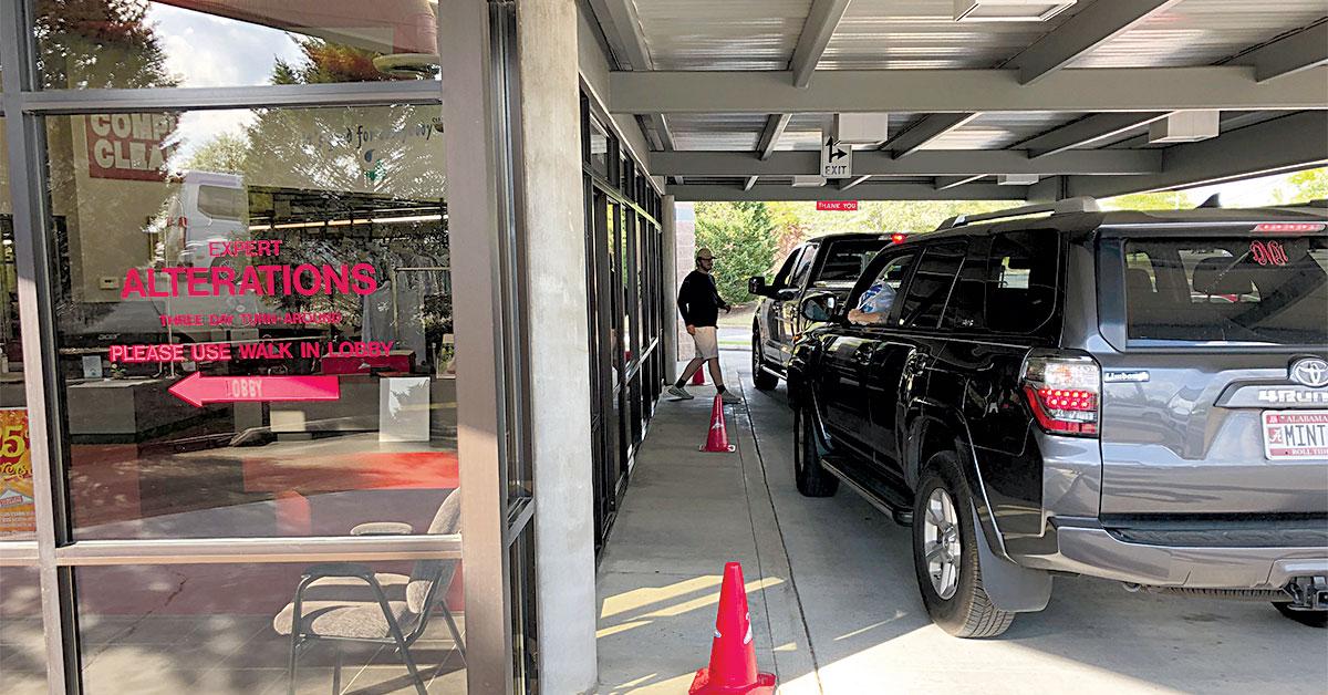 complete cleaners customers in their cars picking up cleaning web