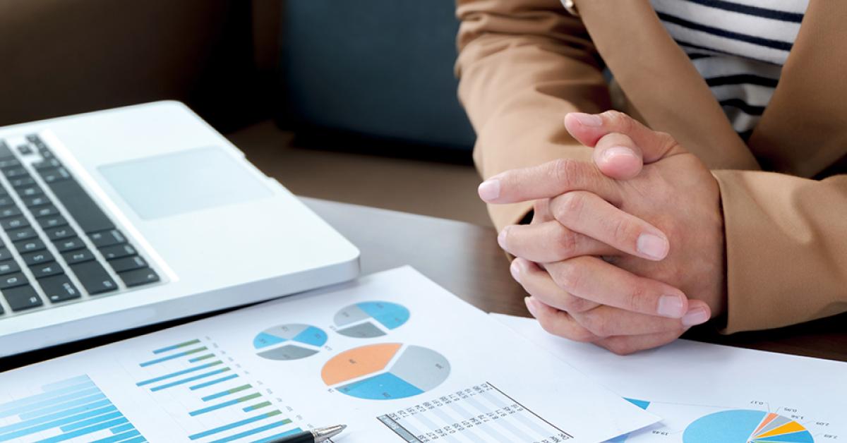 Person looking over business graphs