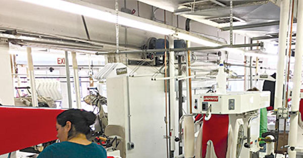 highland woman in finishing area and view outside web