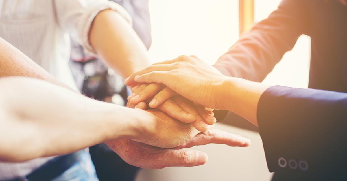 Team members stacking their hands.