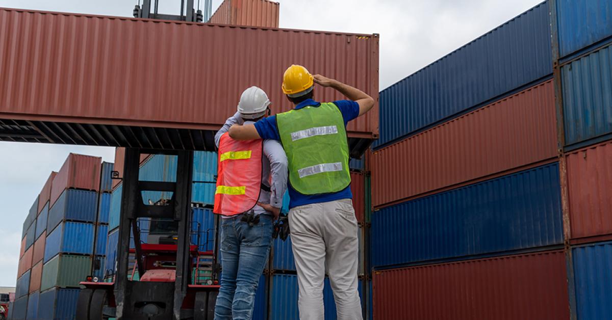 Workers at port with cargo containers
