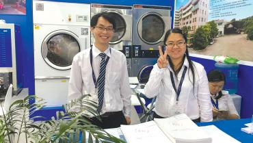 texcare asia 2017 two young people at booth smiling web