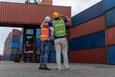 Workers at port with cargo containers